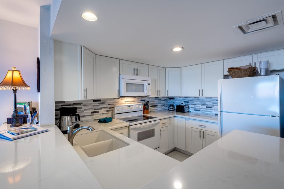 Spacious Kitchen with plenty of counter top and comforotable stools for a nice seating/eating option