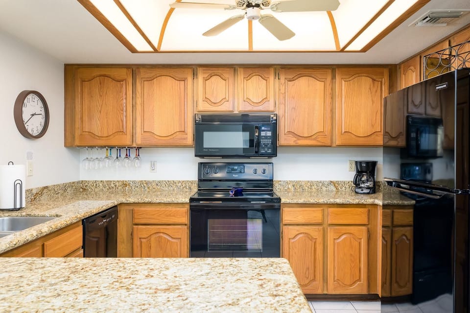 Fully stocked kitchen with granite counter tops.
