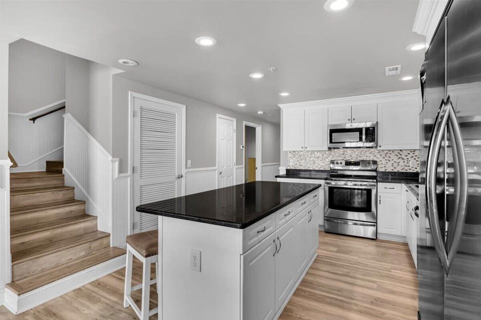 Kitchen with island and stairs to second floor