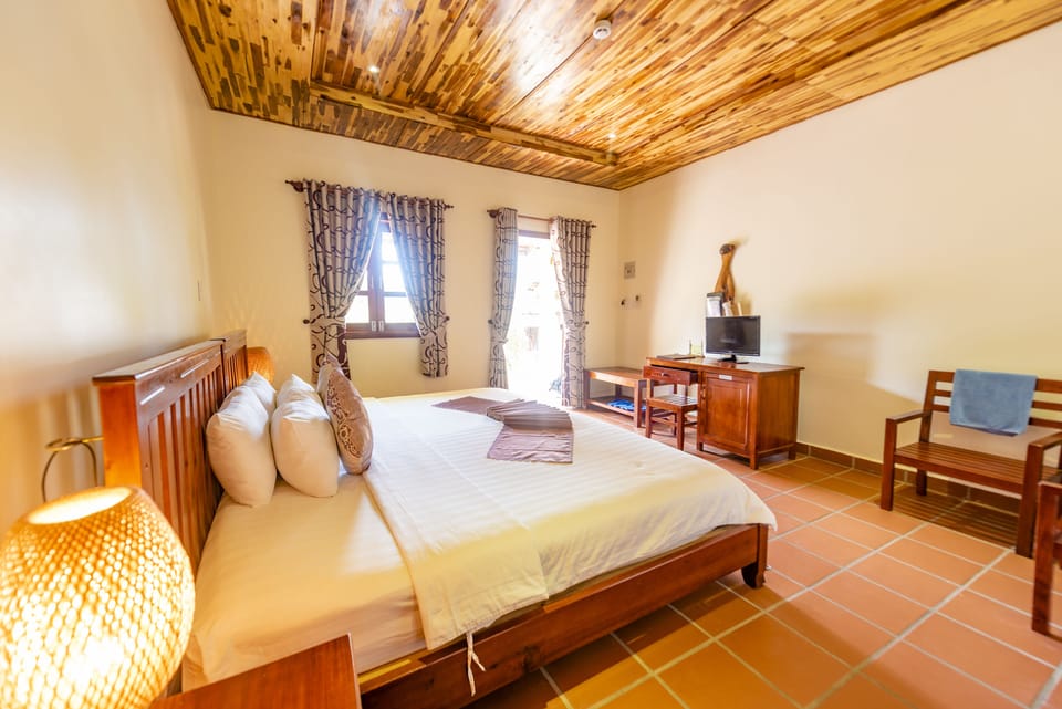 Deluxe Room, Partial Sea View | Minibar, in-room safe, desk, blackout drapes