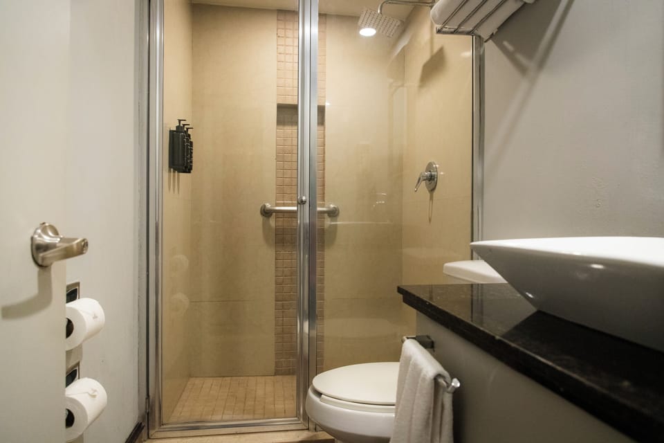 Luxury Room, 2 Double Beds | Bathroom | Shower, free toiletries, hair dryer, towels