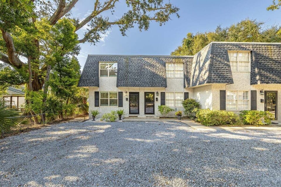 Property exterior with gravel driveway and landscaping