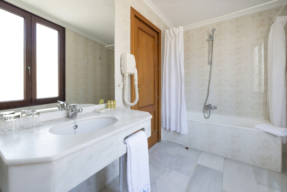 Bathtub, eco-friendly toiletries, hair dryer, bidet