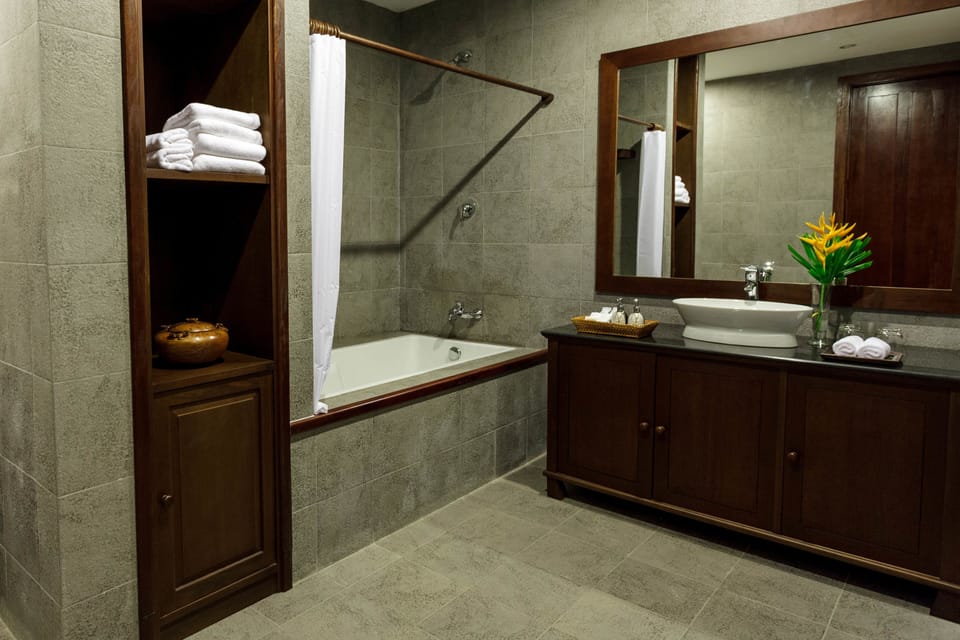 Deluxe Suite, 1 King Bed, River View | Bathroom | Combined shower/tub, hair dryer, bathrobes, slippers