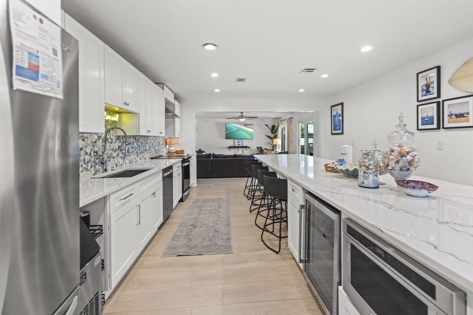 Your spacious kitchen features gleaming marble counters, modern appliances, and a breakfast bar where you'll love sipping morning coffee together.