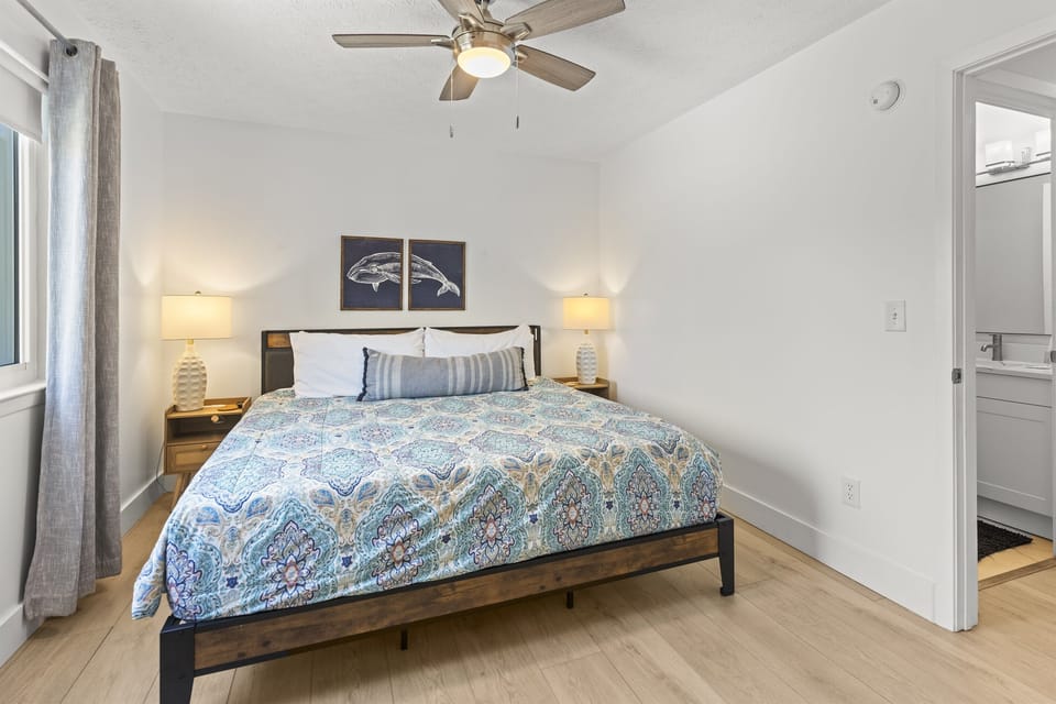 Drift off to sleep in your serene bedroom with coastal touches and a gentle ceiling fan.