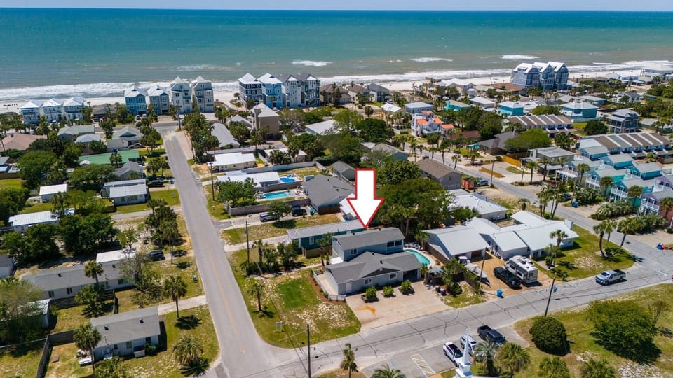Beachfront vacation rental community with pristine white sand beach and crystal-clear waters nearby.