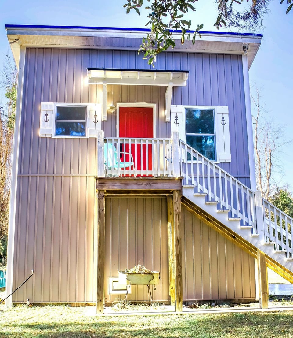 Tiny House Talk 
https://tinyhousetalk.com/cute-quirky-tiny-house-by-the-marsh/