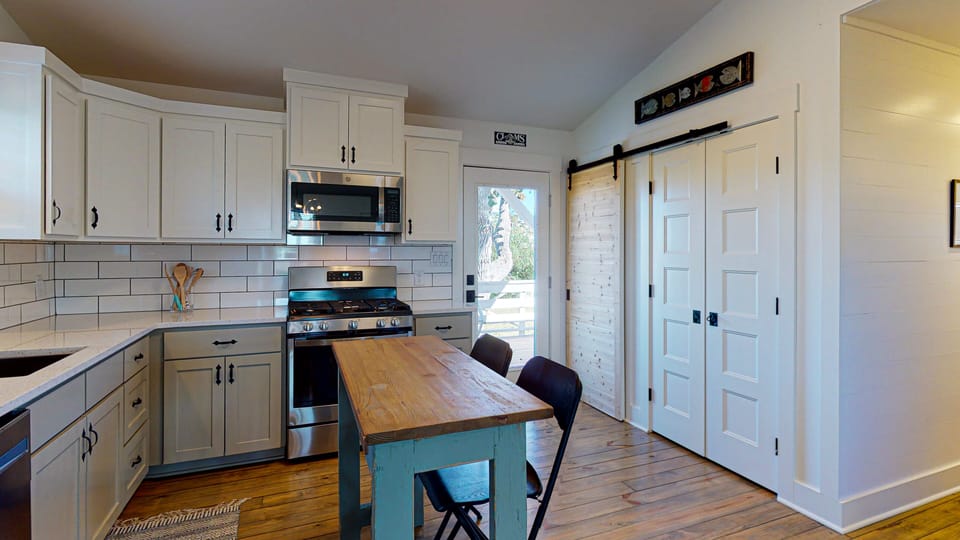 Pantry and washer and dryer behind door in kitchen.