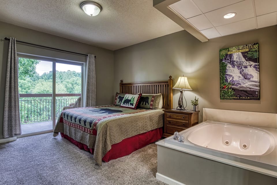 Master bedroom features a king size bed, jacuzzi tub, and access to the balcony