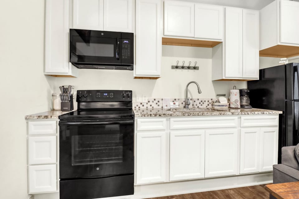 The kitchen features modern appliances, gleaming granite countertops, and plenty of cabinet space
