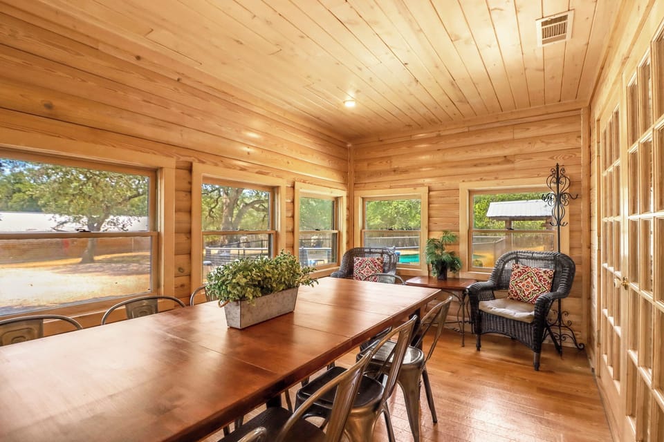 The dining table overlooks the backyard, while cozy wicker seating invites you to linger with morning coffee or unwind after exploring.