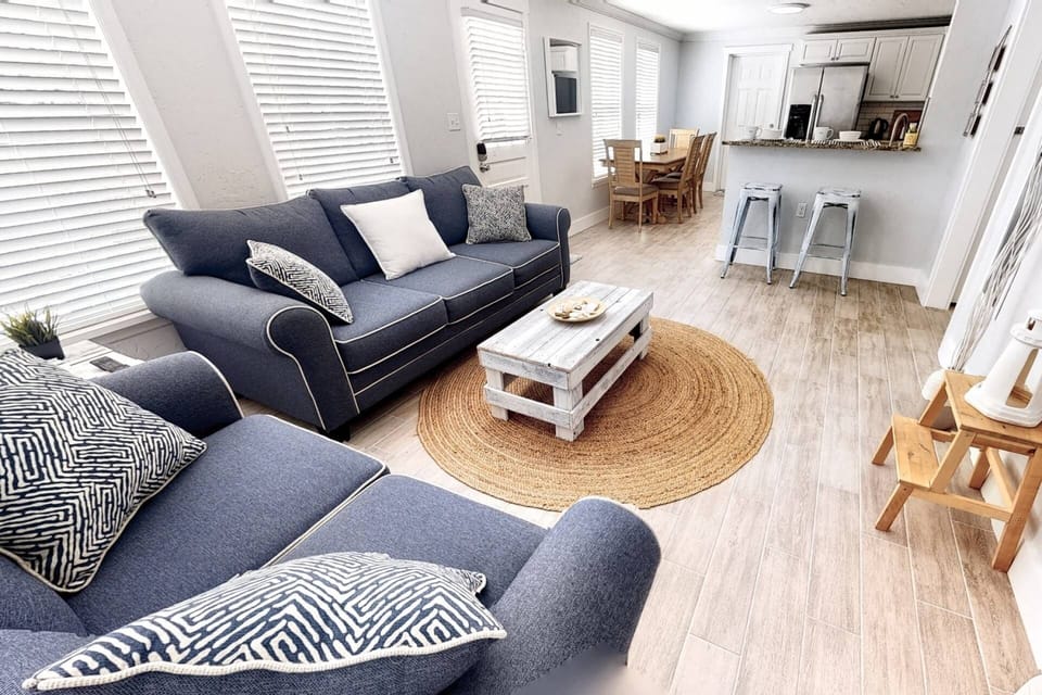 Beautiful living room area perfectly arranged around the wall-mounted flat screen...