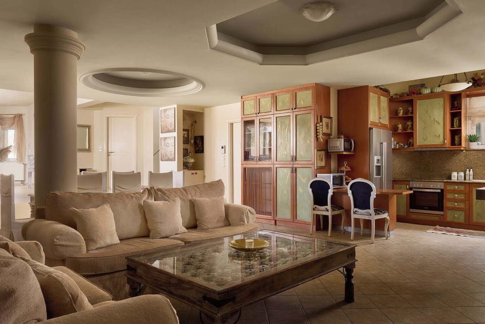 The spacious living room at the lower floor featuring a fully equipped kitchen.