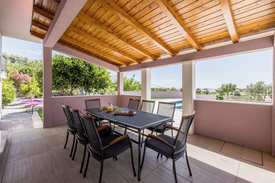 Outdoor dining room area in front of living room and kitchen. 