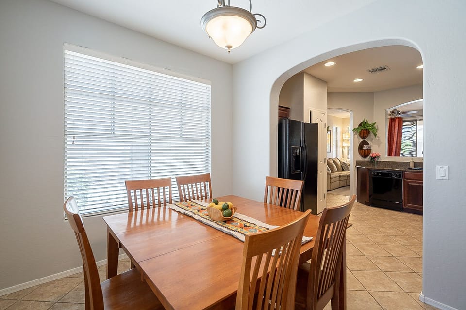 Six person table in the bright & cheerful dining room.