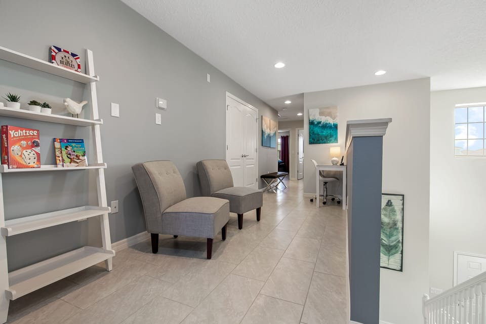View 2 of spacious upstairs area with convenient desk and chair and board games