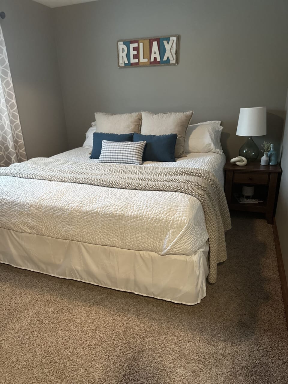 Main floor bedroom w/ King bed, luxurious bed linens and TV.