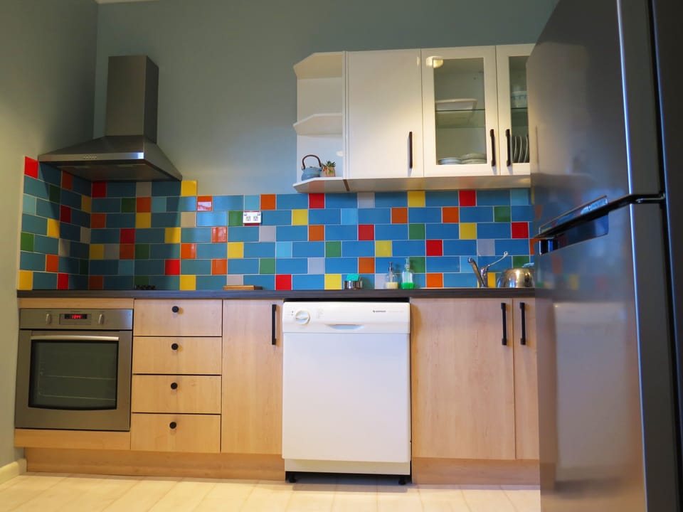 full kitchen with cooktop, oven, microwave, full size fridge, dishwasher, etc