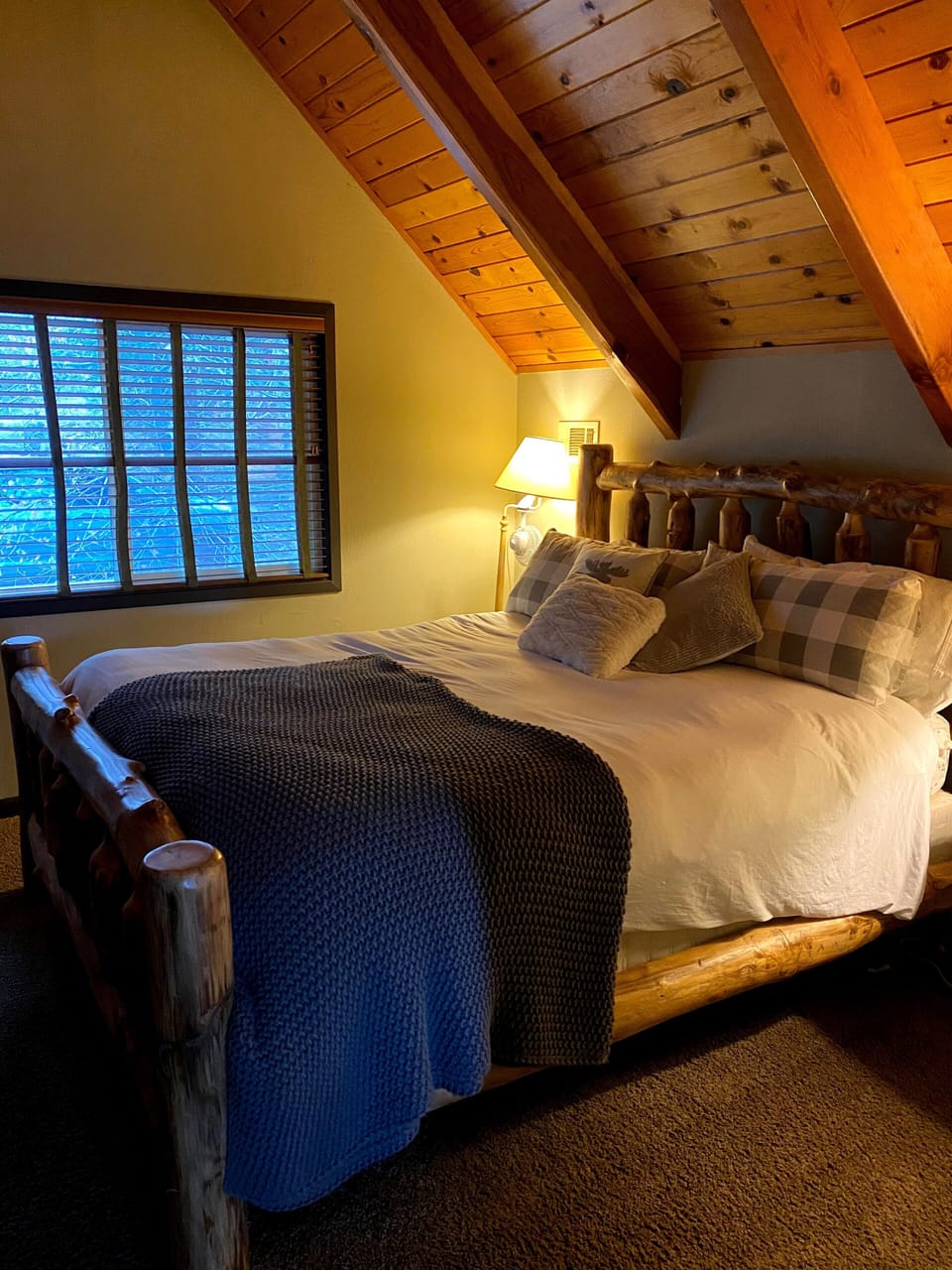 Master bedroom with king size bed and A-frame wood ceiling