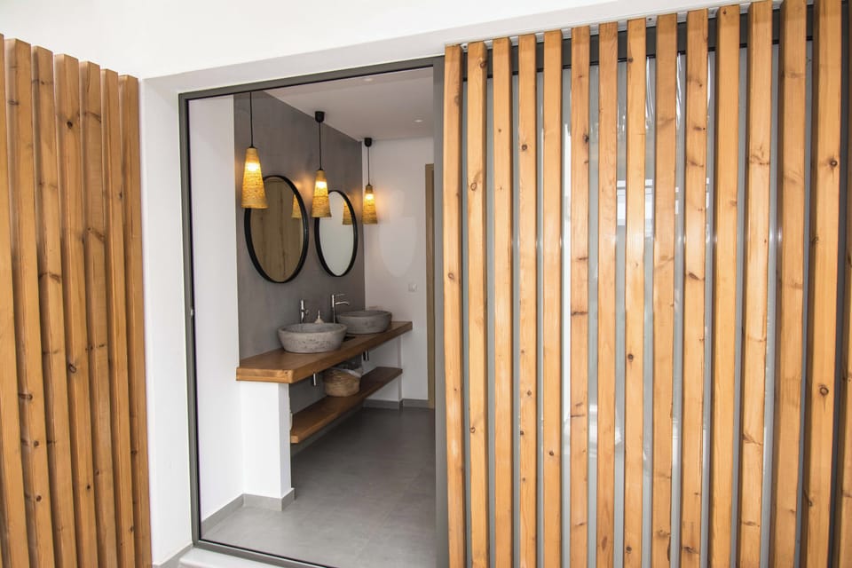 Shower, designer toiletries, hair dryer, slippers