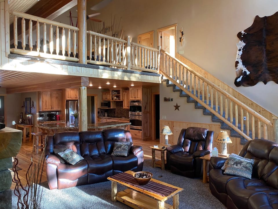 Enjoy the airy open floorplan and comfortable leather couches