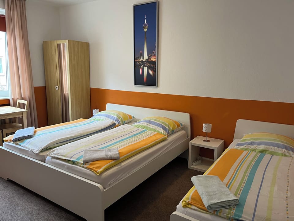 Triple Room, Non Smoking, Shared Bathroom | Iron/ironing board, free WiFi, bed sheets