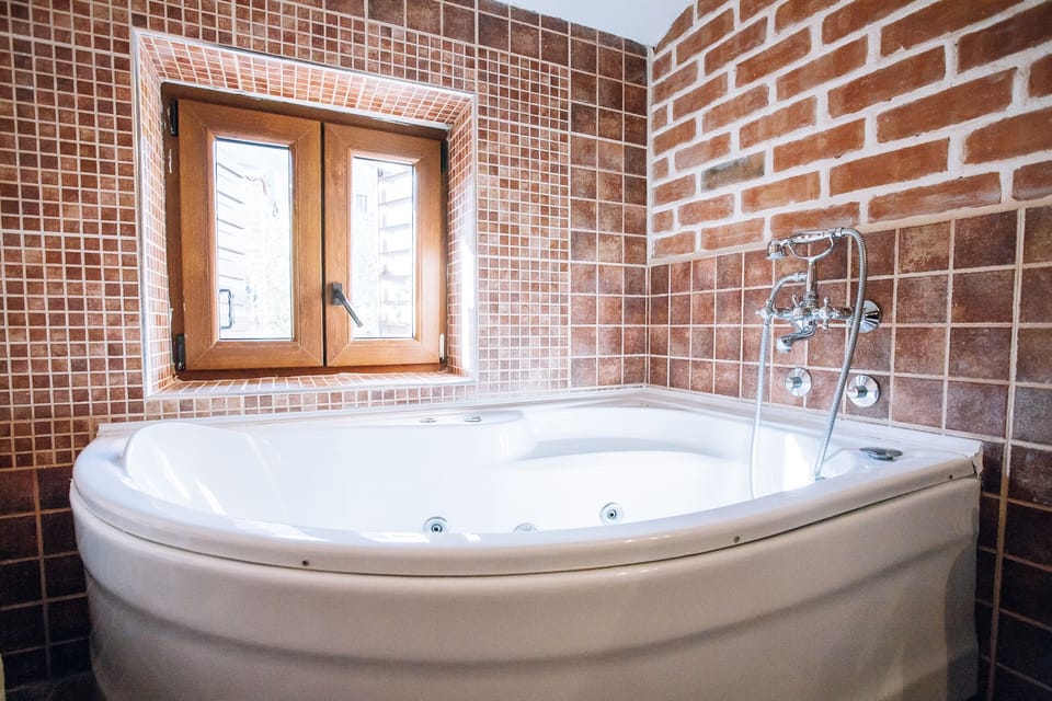 Family Suite, Terrace | Bathroom amenities | Combined shower/tub, designer toiletries, hair dryer, bathrobes