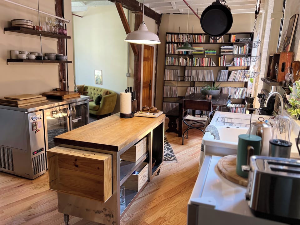 Chef's kitchen, walnut dining table & curated vinyl + book library