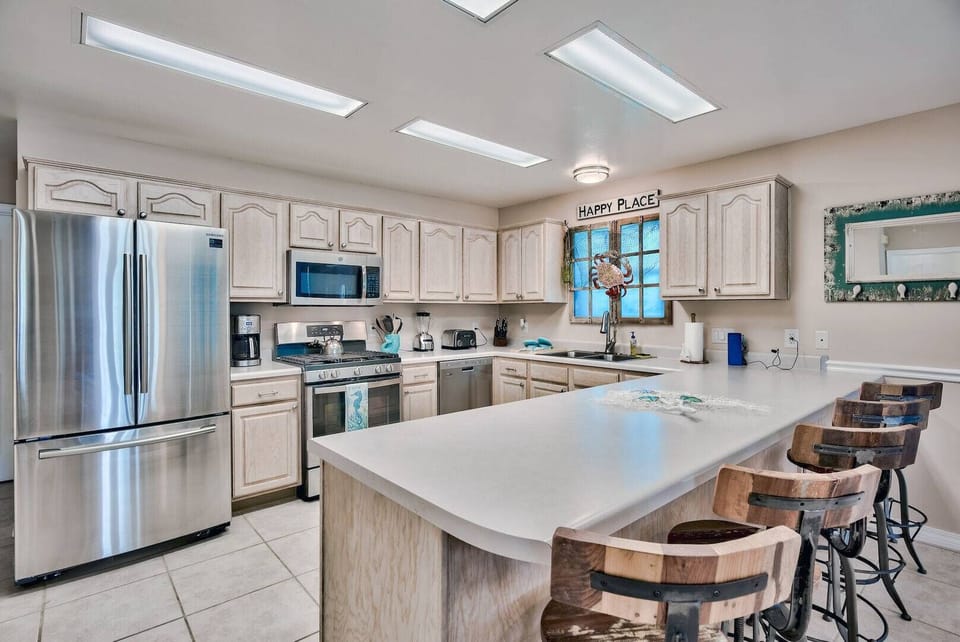 Modern kitchen w/ island seating & stainless steel appliances