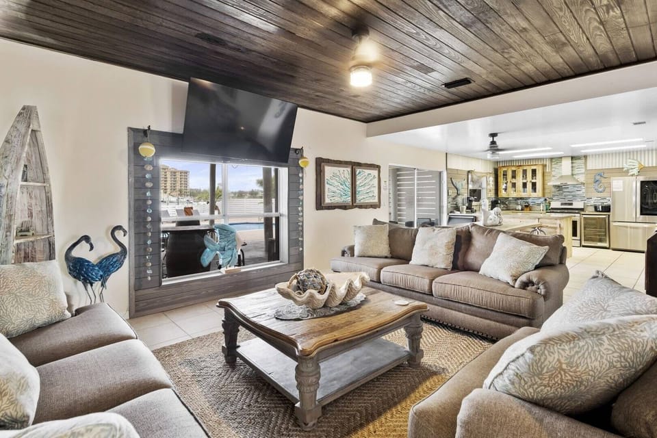 Bright living room w/ plush seating, TV, & an easygoing coastal vibe