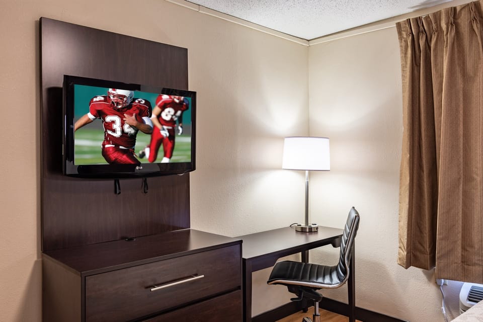 Desk, laptop workspace, blackout drapes, iron/ironing board