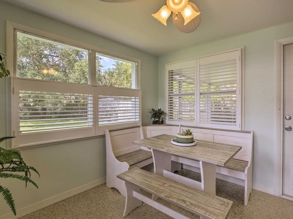 Wood benches around the dining table provide seating for the whole crew.