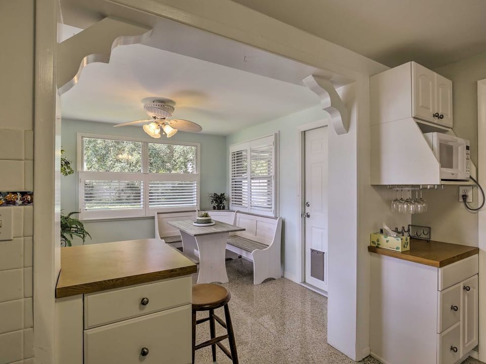 Through the carved archway, the dining table rests in a sun-soaked nook.