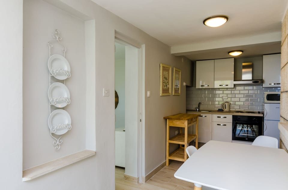 Apartment (Two Bedroom Apartment with Sea View -) | Private kitchen | Fridge, highchair, dining tables