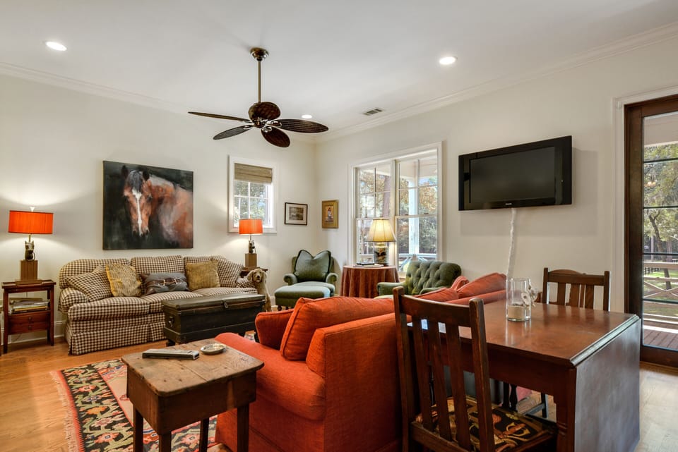 Open great room, open to kitchen and dining , red sofa opens to queen sleeper
