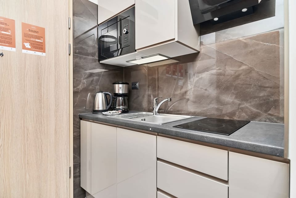 The fully equipped kitchenette includes everything you need for a home-cooked meal.