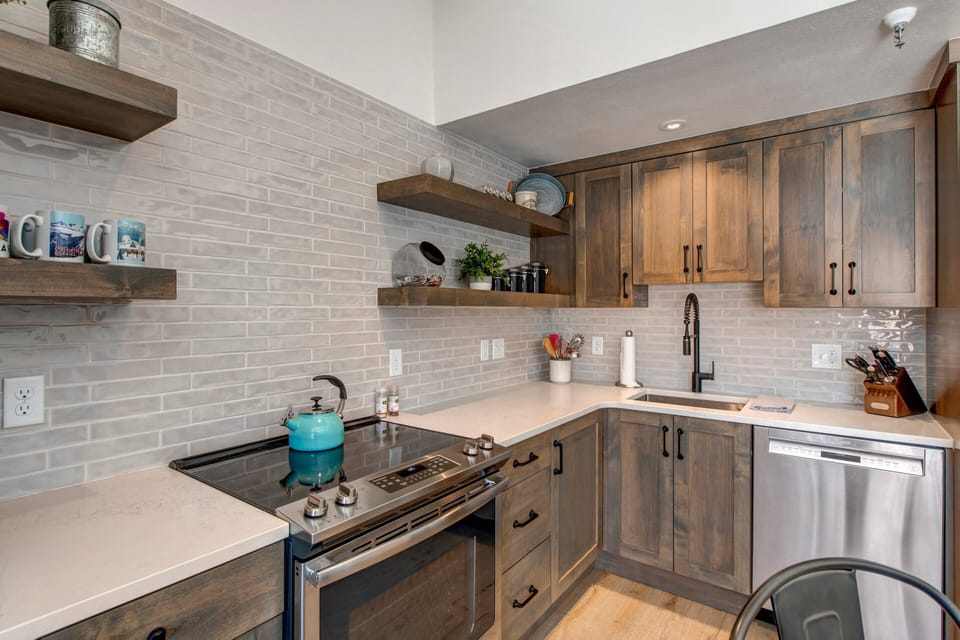 Stainless Steel Appliances Including a 5-Burner Electric Range with a Convection Oven
