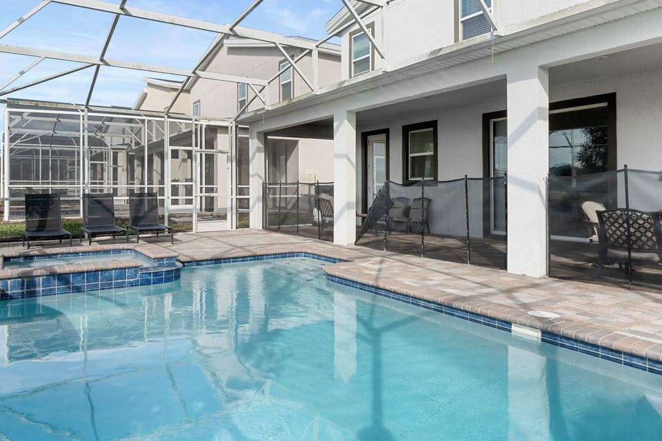 Your private heated pool awaits, perfectly framed by screened lanai and comfortable poolside seating for ultimate relaxation.