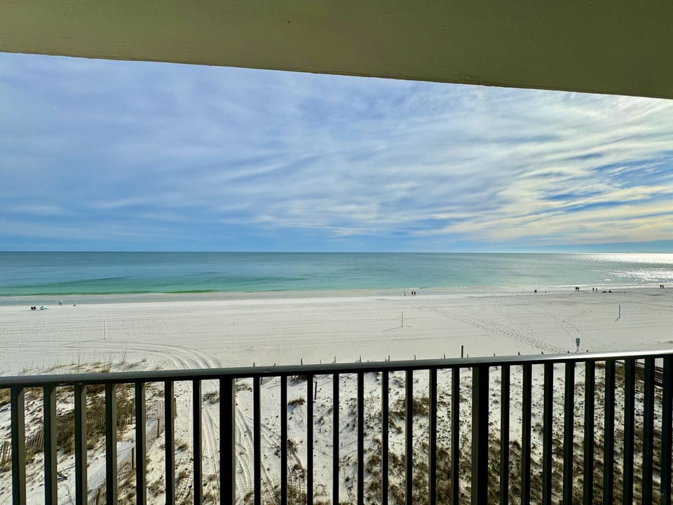 The bar height chairs give you the best view of the white sand and rolling waves