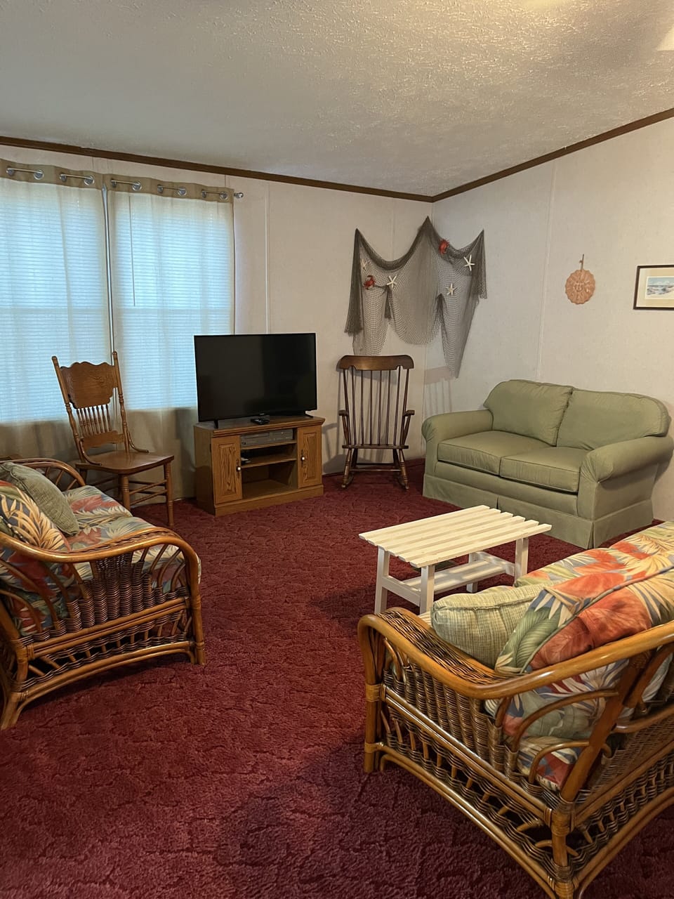 Main living space - Couch, 2 loveseats, and Roku TV - Partial open to kitchen.