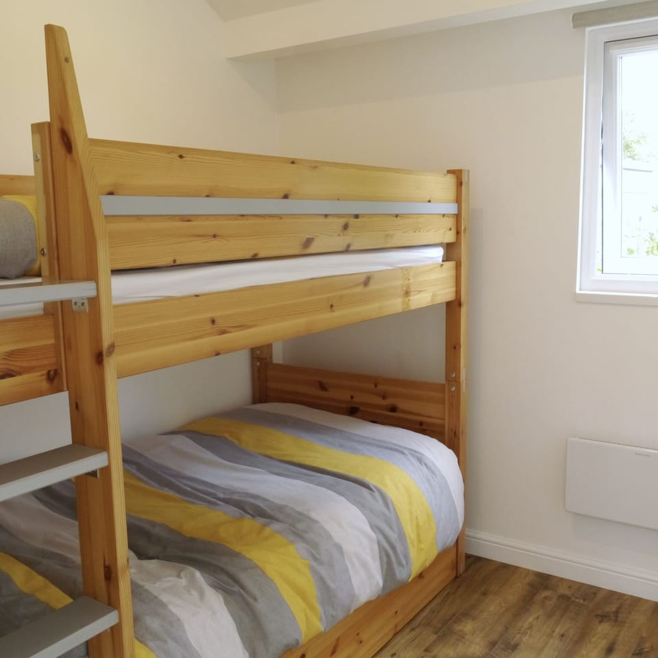 Cosy bunk room with under-bed storage space.