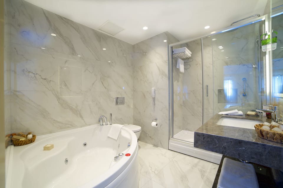 Suite, 1 King Bed | Bathroom | Spring water tub, designer toiletries, hair dryer, slippers