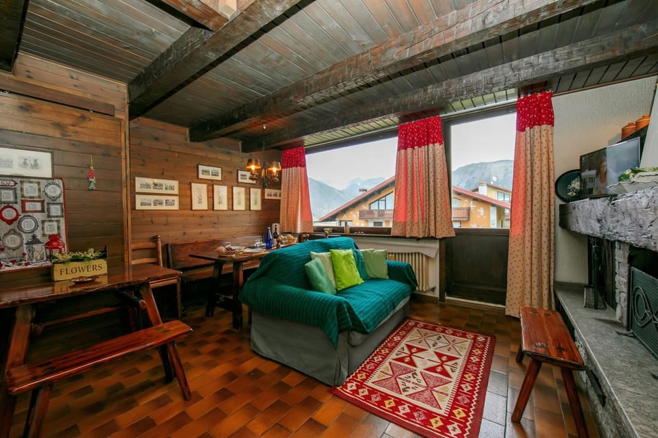 Family Apartment, 1 Bedroom, Fireplace, Mountainside (Arianna) | Living area | 24-inch flat-screen TV with satellite channels, TV, fireplace