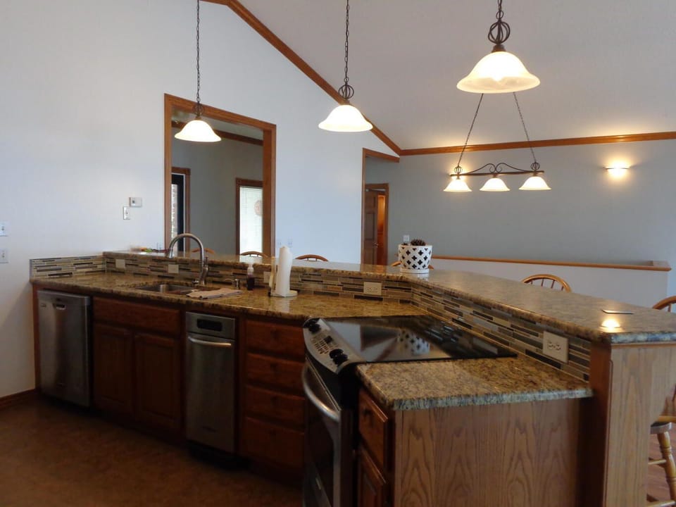Open kitchen with all stainless steel appliances.  