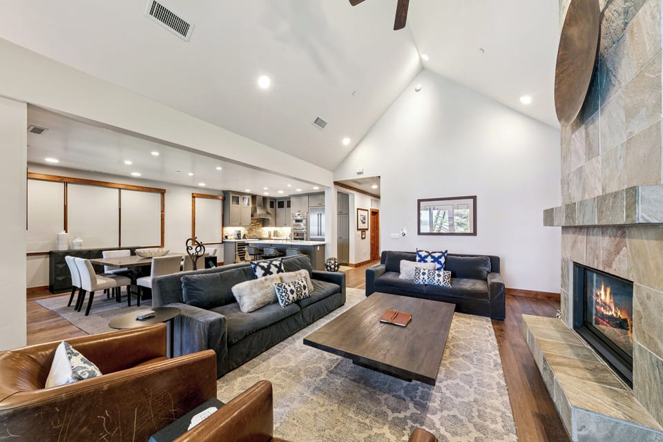 Bright, open living area filled with natural light and panoramic lake views through large windows