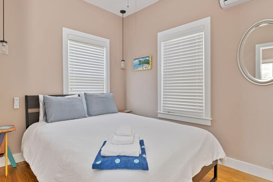 Front bedroom with queen bed, ceiling fan and a/c