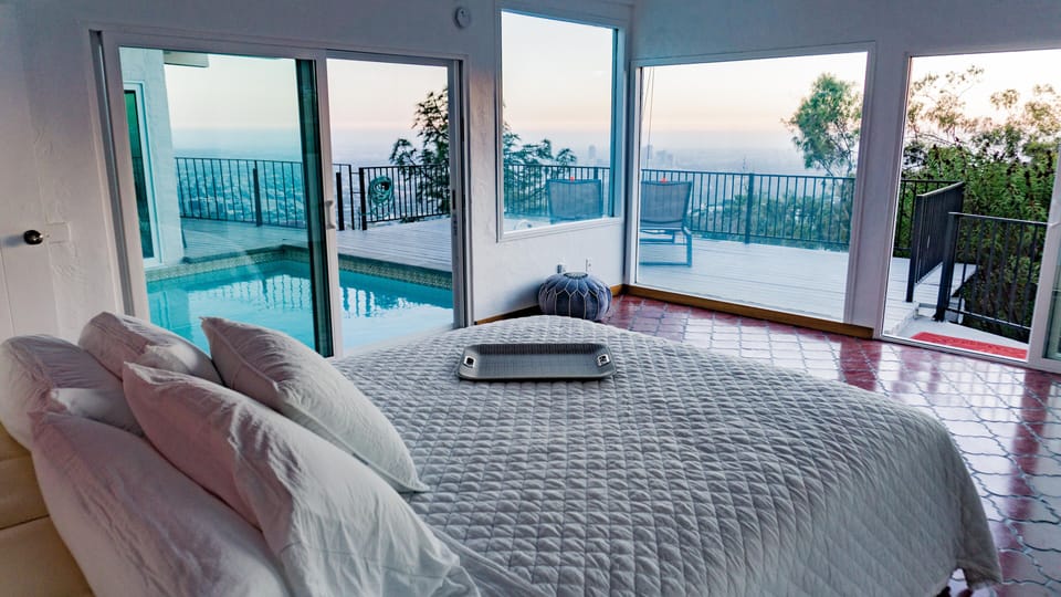 Master bedroom with pool and city views