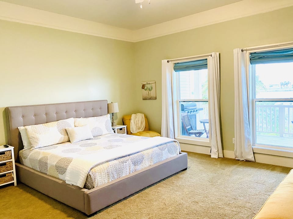 Master bedroom with private bathroom, king size bed and pull out ottoman bed.