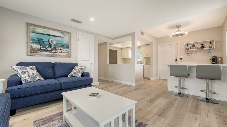 Spacious living room with seating for 5, flat panel HDTV off of the kitchen and dining room